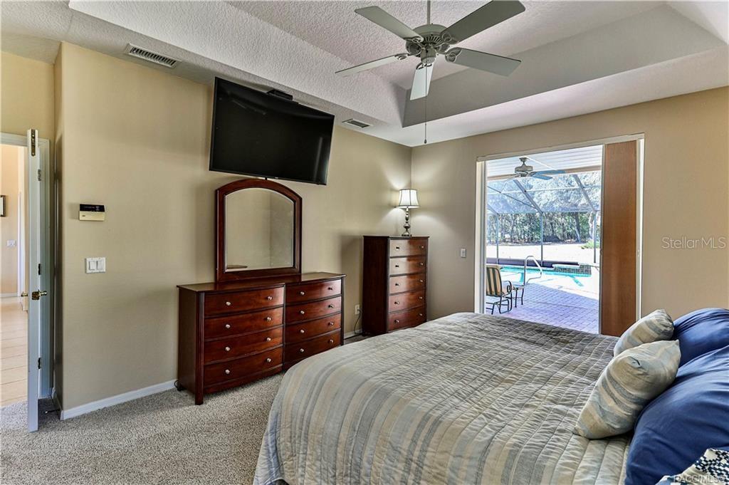 5420 North Rosedale Circle Beverly Hills, FL 34465 - Photo 23 of 49 a bedroom with a bed and a flat screen tv