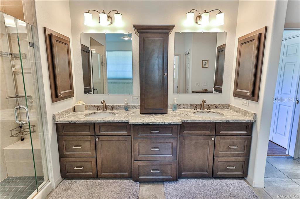 5420 North Rosedale Circle Beverly Hills, FL 34465 - Photo 24 of 49 a bathroom with a double vanity sink and a mirror