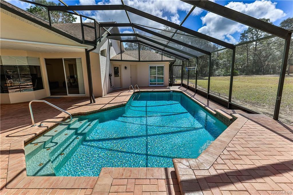 5420 North Rosedale Circle Beverly Hills, FL 34465 - Photo 35 of 49 a view of a backyard with wooden floor and iron fence