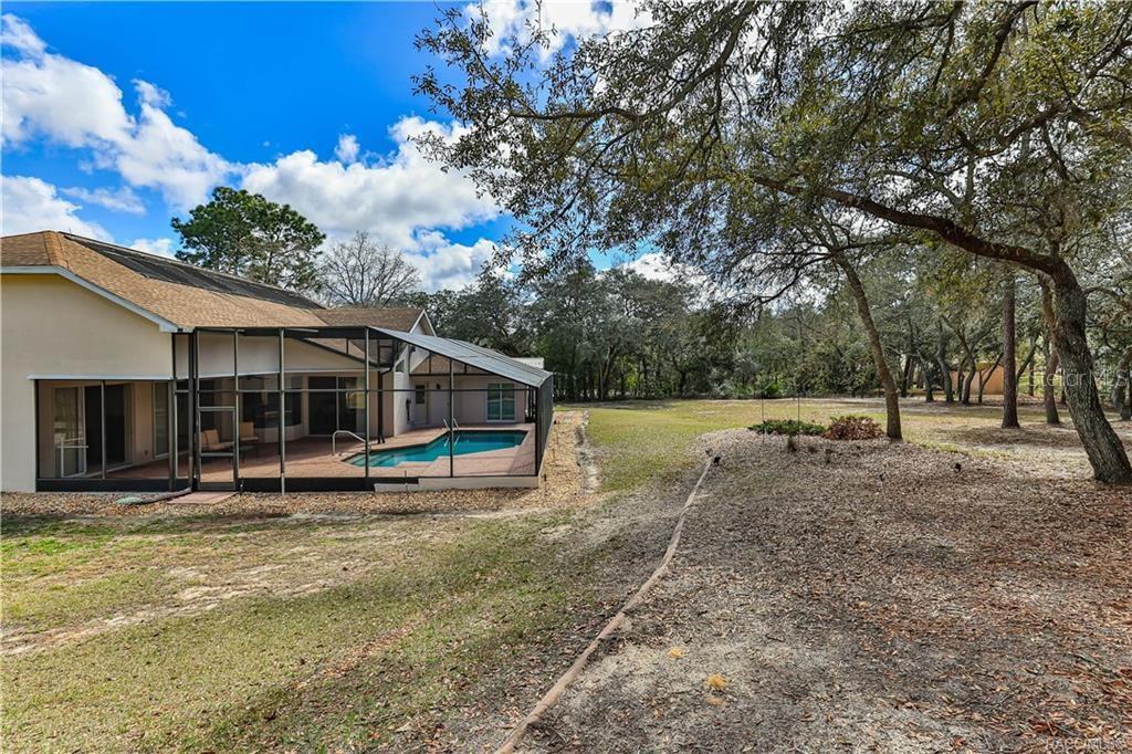 5420 North Rosedale Circle Beverly Hills, FL 34465 - Photo 46 of 49 a view of a house with backyard and trees