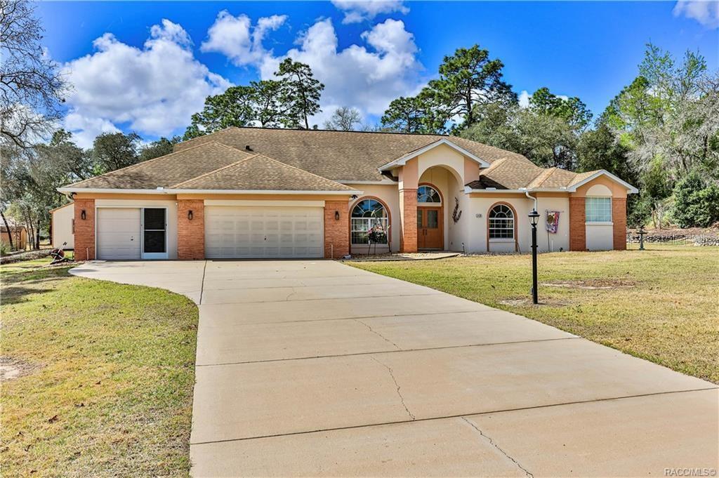 5420 North Rosedale Circle Beverly Hills, FL 34465 - Photo 49 of 49 a view of a white house with a big yard and large trees