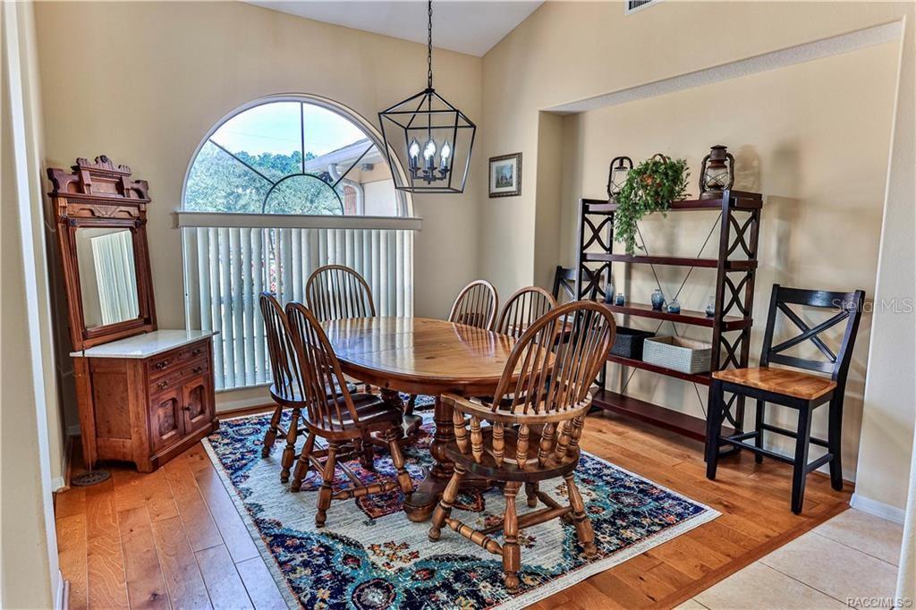 5420 North Rosedale Circle Beverly Hills, FL 34465 - Photo 7 of 49 a view of a dining room with furniture wooden floor and a chandelier