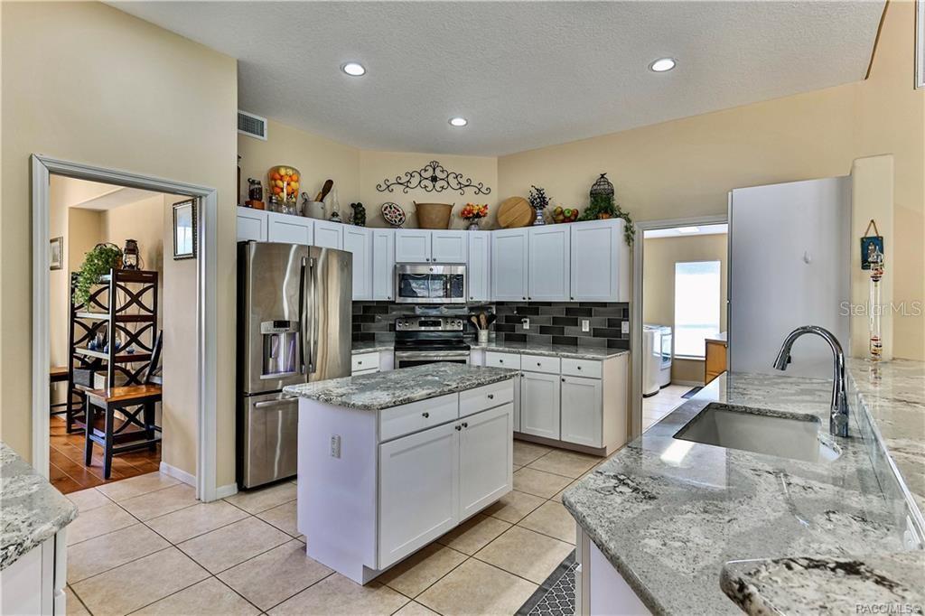 5420 North Rosedale Circle Beverly Hills, FL 34465 - Photo 9 of 49 a kitchen with stainless steel appliances granite countertop a refrigerator sink and stove
