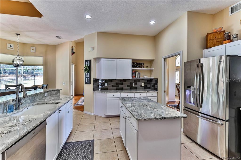 5420 North Rosedale Circle Beverly Hills, FL 34465 - Photo 10 of 49 a large kitchen with a center island a counter space stainless steel appliances and cabinets