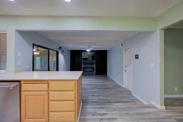 an empty room with closet and chandelier fan