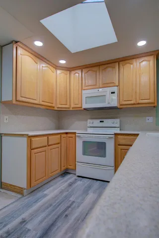 a view of a house with a yard and tree s