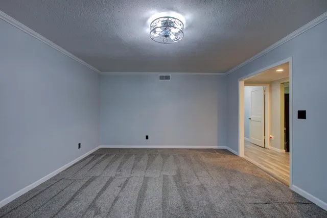 a kitchen with granite countertop wooden floors stainless steel appliances and sink
