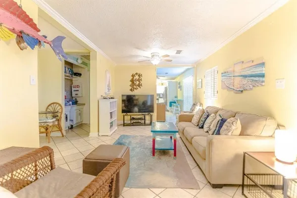 a living room with furniture and a chandelier