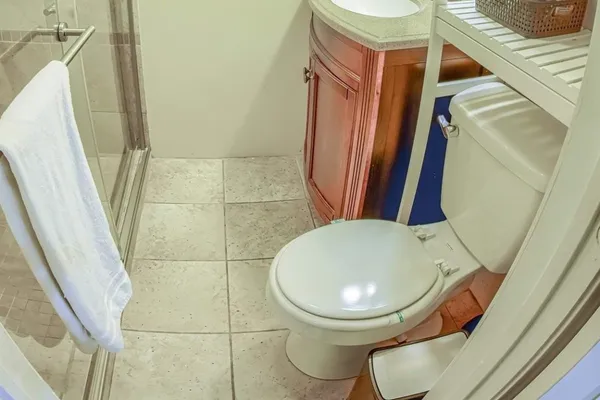 a bathroom with a toilet and a mirror