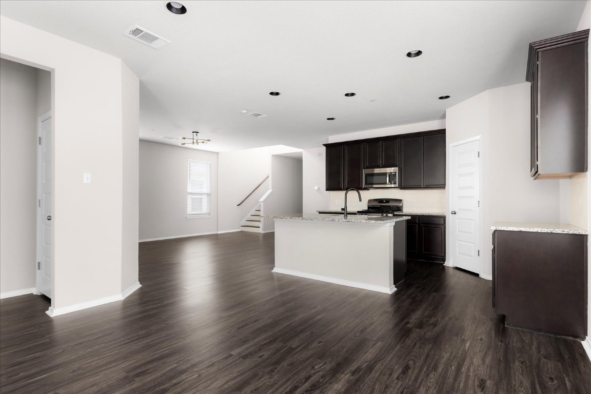2800 Joe Dimaggio Boulevard, Unit 100 Round Rock, TX 78665 - Photo 33 of 33 a kitchen with stainless steel appliances a refrigerator and a microwave