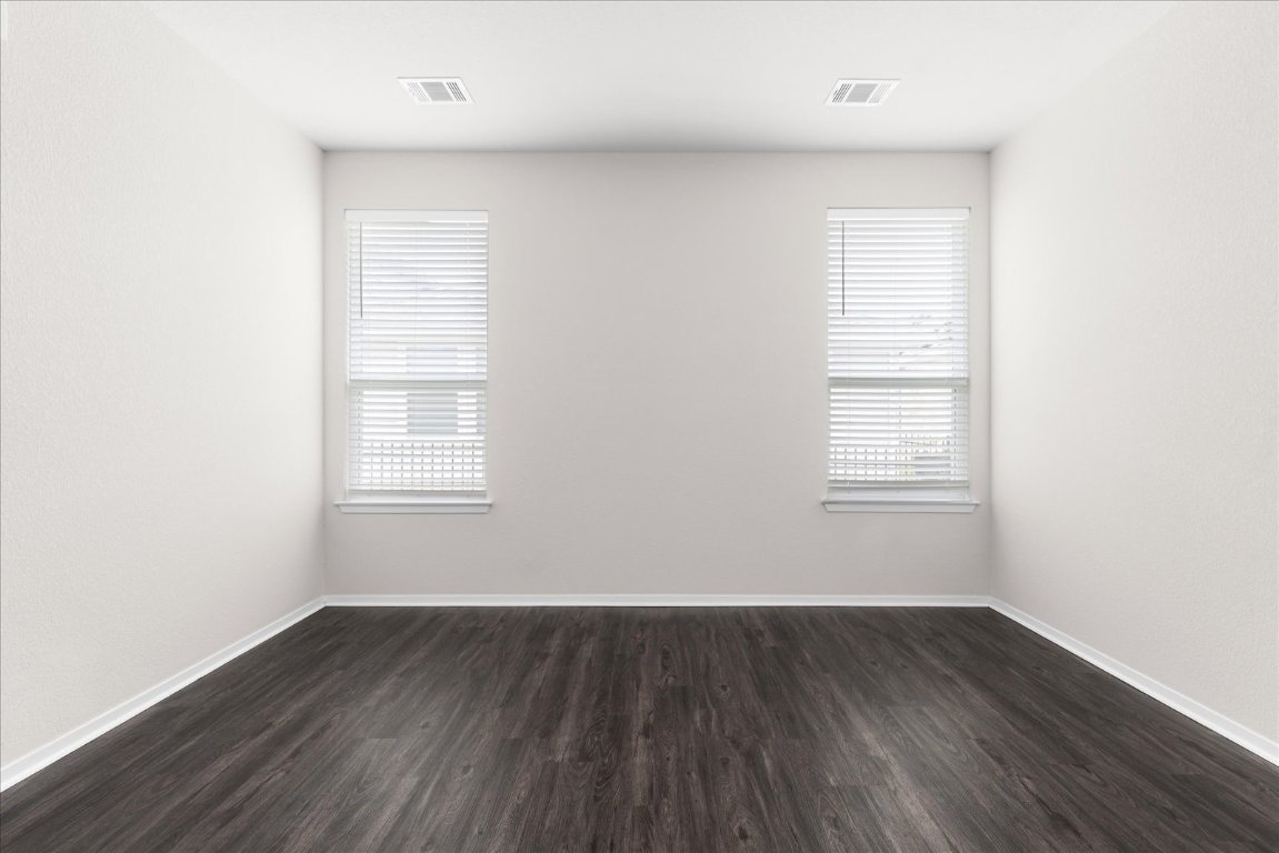 2800 Joe Dimaggio Boulevard, Unit 100 Round Rock, TX 78665 - Photo 12 of 33 an empty room with wooden floor and windows