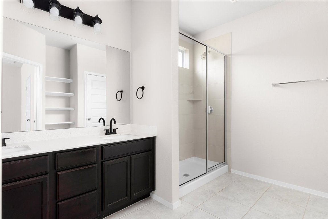 2800 Joe Dimaggio Boulevard, Unit 100 Round Rock, TX 78665 - Photo 14 of 33 a bathroom with a sink a toilet and shower