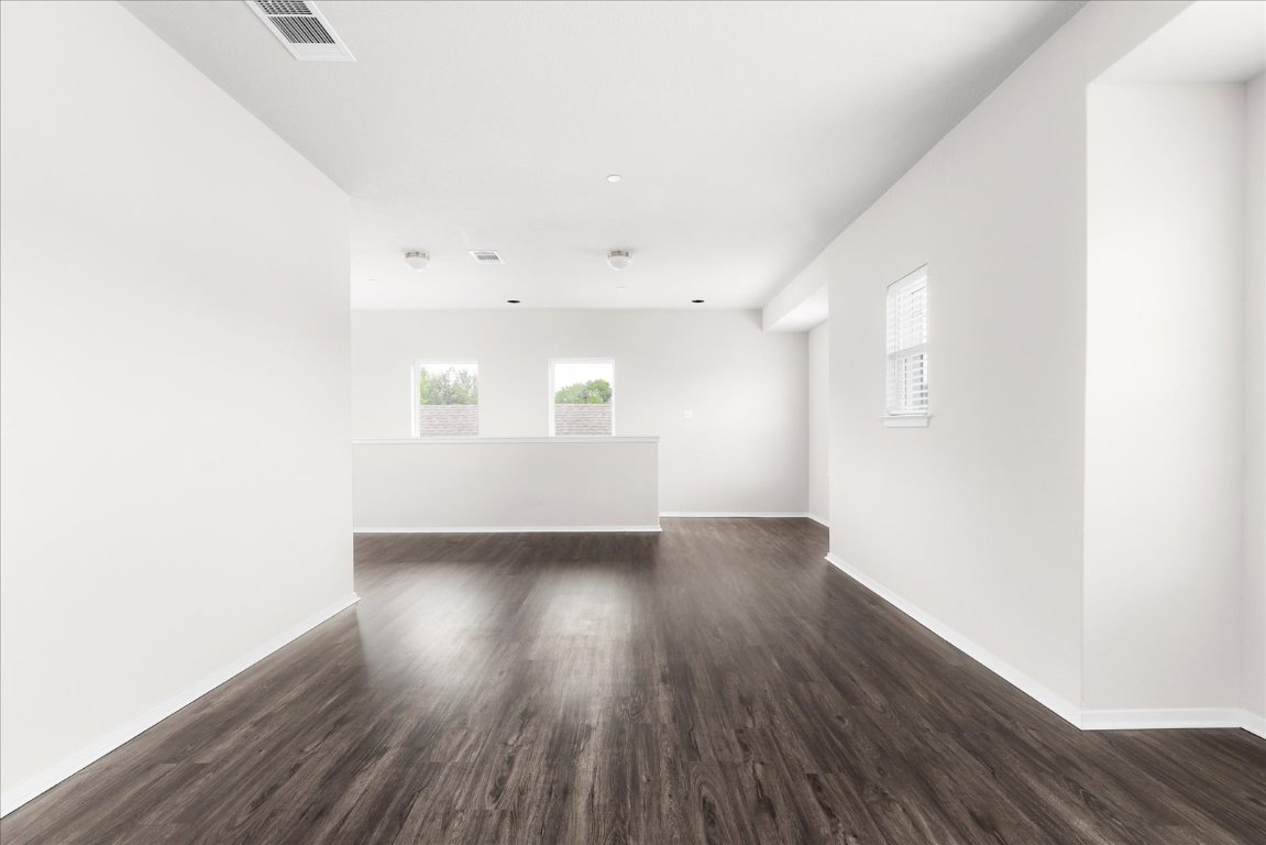 2800 Joe Dimaggio Boulevard, Unit 100 Round Rock, TX 78665 - Photo 18 of 33 a view of an empty room with wooden floor and a window