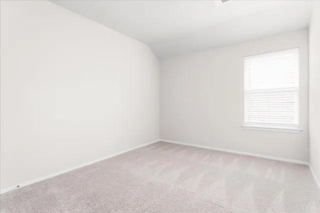 a view of an empty room and wooden floor