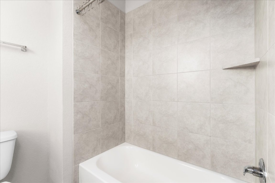 2800 Joe Dimaggio Boulevard, Unit 100 Round Rock, TX 78665 - Photo 26 of 33 a bathroom with a white bath tub and a shower