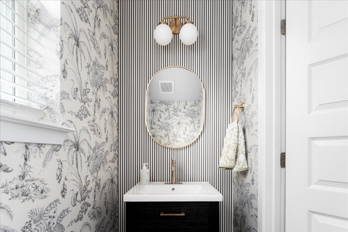 2800 Joe Dimaggio Boulevard, Unit 100 Round Rock, TX 78665 - Photo 4 of 33 a bathroom with a sink and a mirror