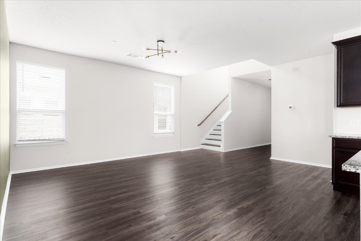 2800 Joe Dimaggio Boulevard, Unit 100 Round Rock, TX 78665 - Photo 5 of 33 an empty room with wooden floor fan and windows