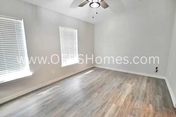 a view of wooden floor and windows in a room