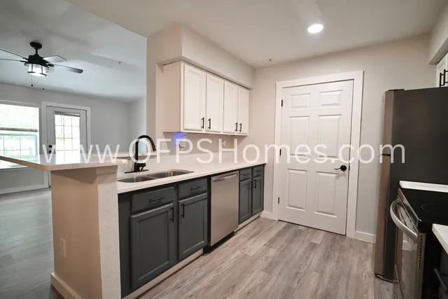 a kitchen with a sink appliances and cabinets