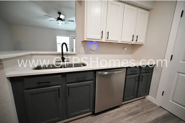 a kitchen with stainless steel appliances granite countertop a sink and cabinets