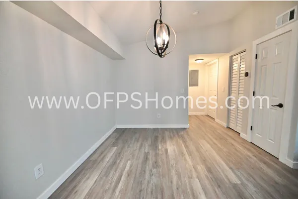 a view of a room with wooden floor