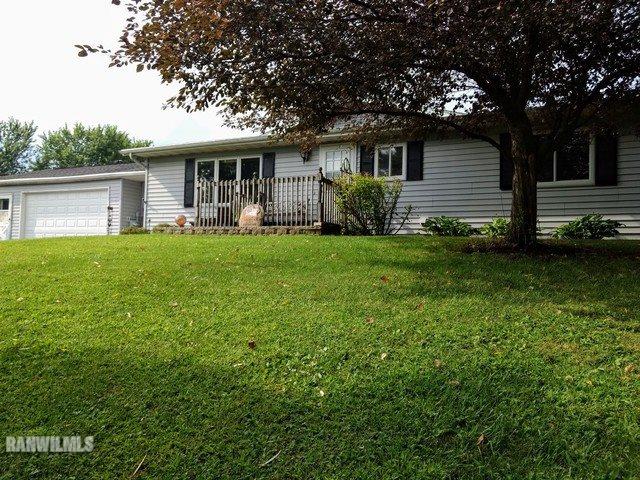 404 West Wilson Road Polo, IL 61064 - Photo 1 of 25 a front view of a house with a garden