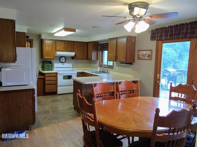 404 West Wilson Road Polo, IL 61064 - Photo 3 of 25 a kitchen with a dining table chairs and refrigerator