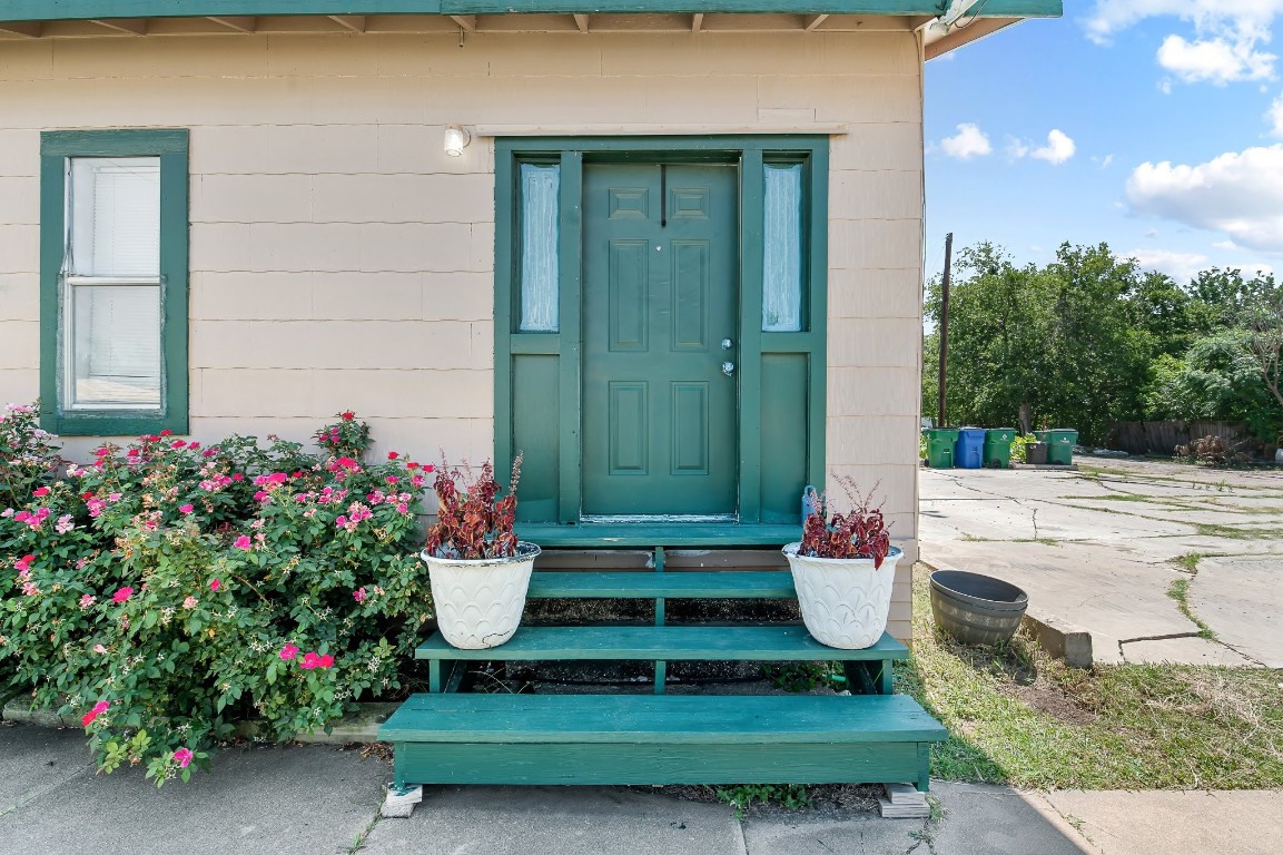 402 East 4th Street Taylor, TX 76574 - Photo 1 of 18 a front view of a house with a garden