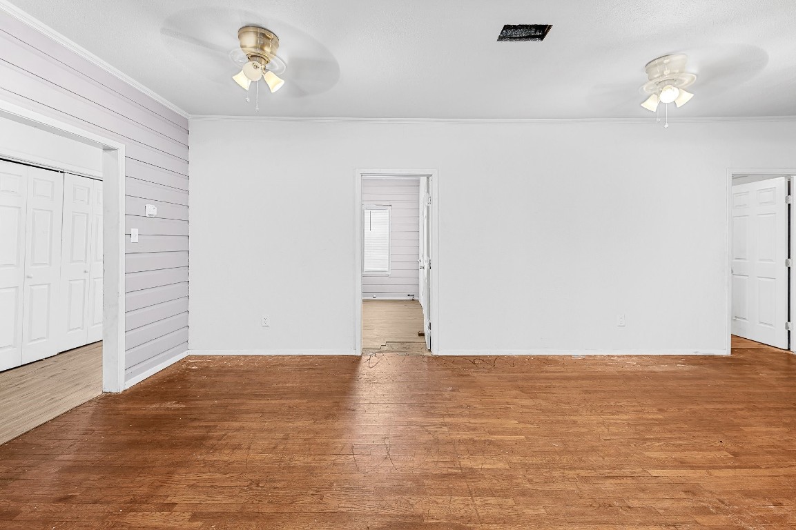 402 East 4th Street Taylor, TX 76574 - Photo 13 of 18 an empty room with wooden floor and windows