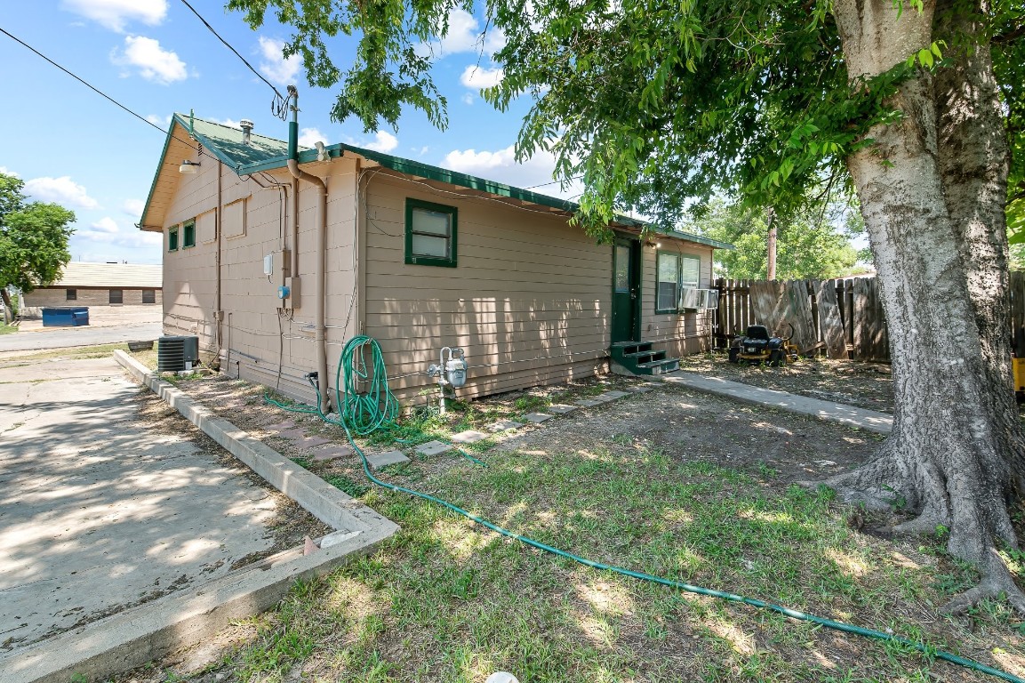 402 East 4th Street Taylor, TX 76574 - Photo 16 of 18 a view of a house with backyard and a tree