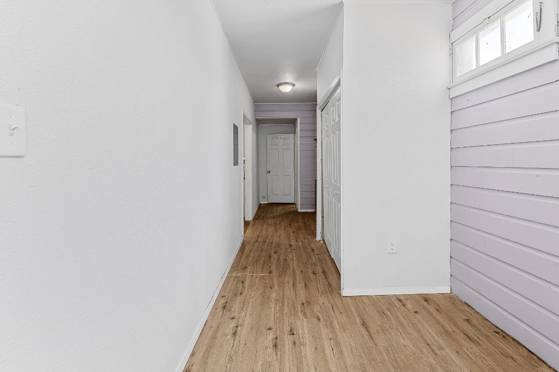 402 East 4th Street Taylor, TX 76574 - Photo 4 of 18 a view of a hallway with wooden floor