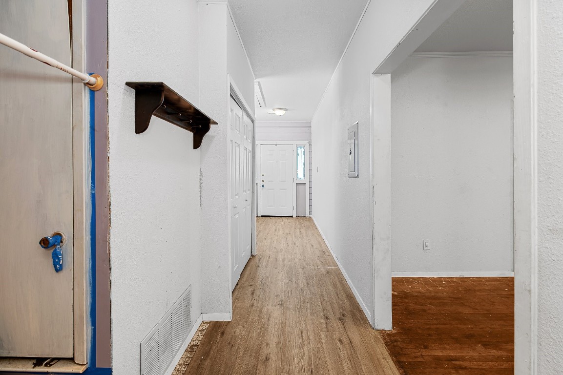 402 East 4th Street Taylor, TX 76574 - Photo 6 of 18 a view of hallway with wooden floor