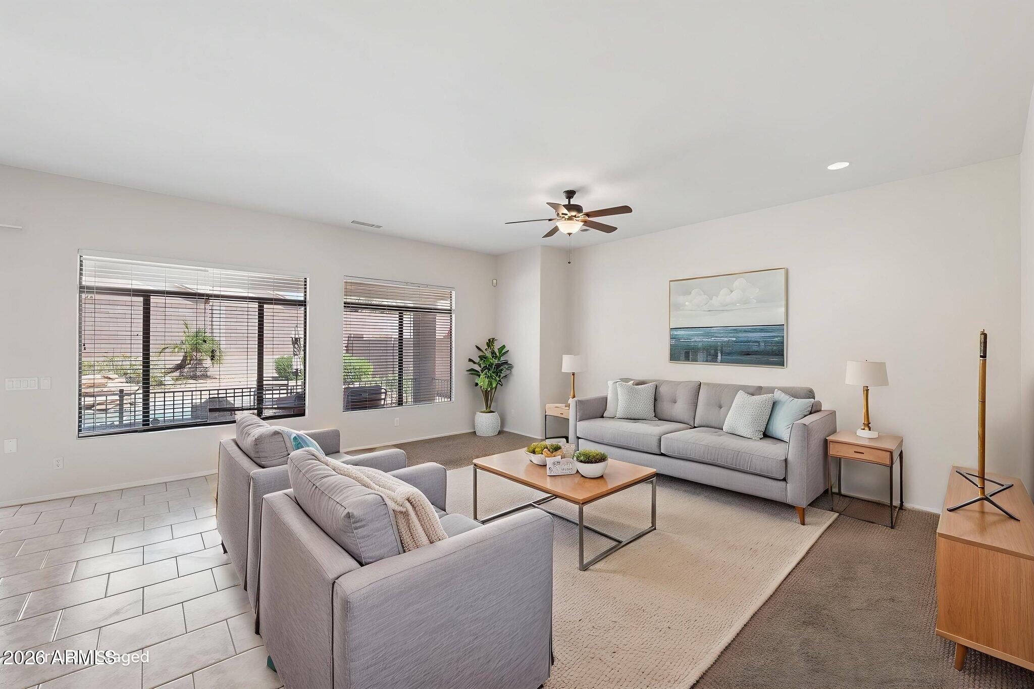 4418 East Jaeger Road Phoenix, AZ 85050 - Photo 4 of 42 a living room with furniture and floor to ceiling windows