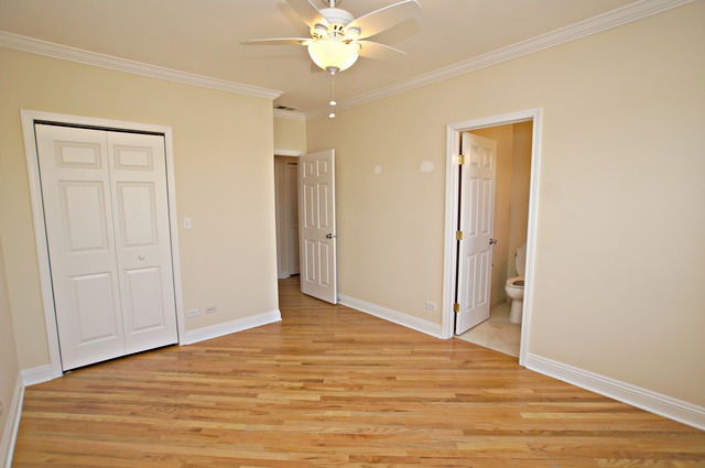 4110 North Keystone Avenue, Unit 3E Chicago, IL 60641 - Photo 15 of 21 a view of a room with wooden floor and ceiling fan