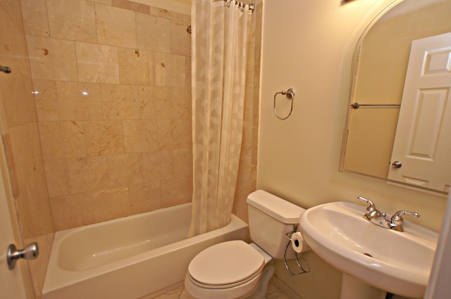4110 North Keystone Avenue, Unit 3E Chicago, IL 60641 - Photo 18 of 21 a bathroom with a sink toilet and shower