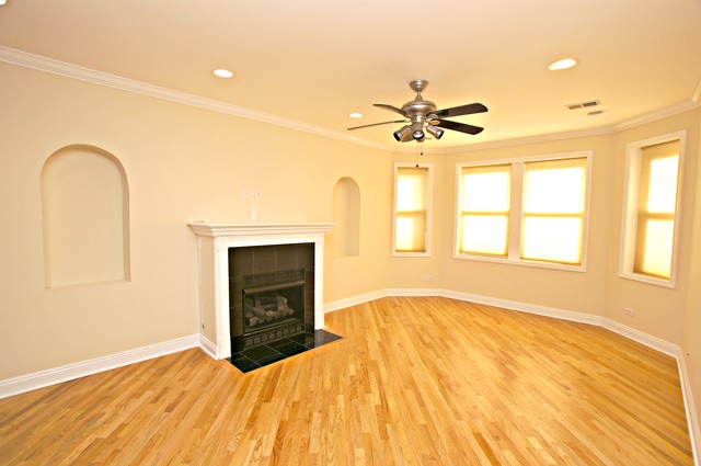 4110 North Keystone Avenue, Unit 3E Chicago, IL 60641 - Photo 7 of 21 a bedroom with a bed and a chandelier