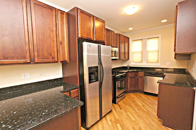 4110 North Keystone Avenue, Unit 3E Chicago, IL 60641 - Photo 10 of 21 a kitchen with stainless steel appliances granite countertop a refrigerator and a sink