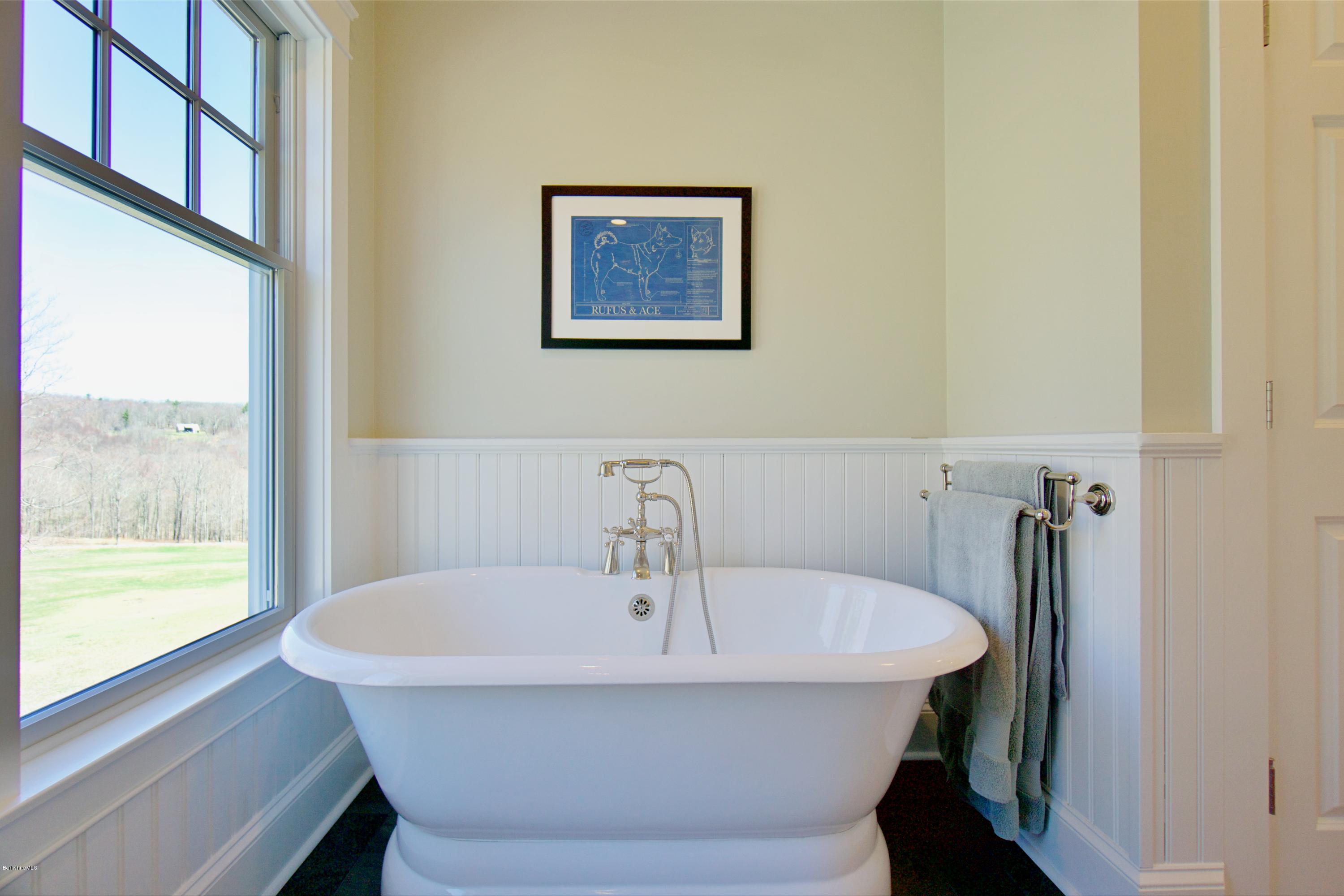 32 Oxbow Road Egremont, MA 01230 - Photo 15 of 35 a white bath tub sitting in a bathroom next to a window