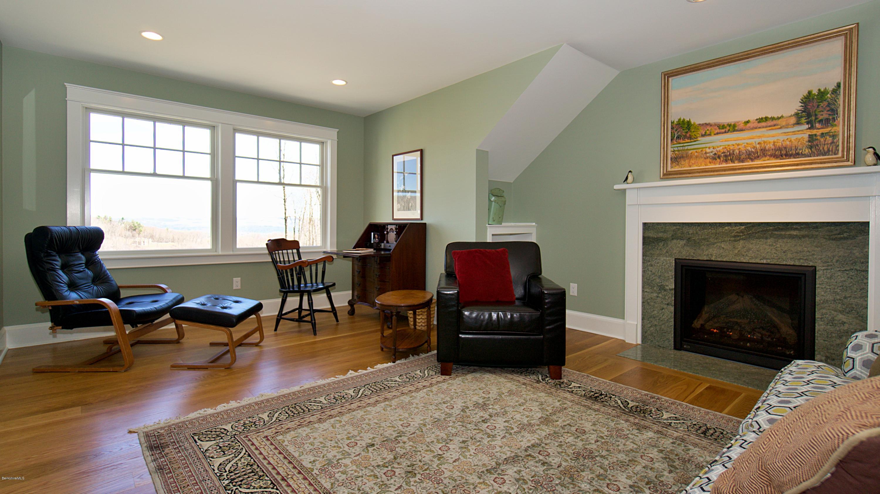 32 Oxbow Road Egremont, MA 01230 - Photo 24 of 35 a living room with furniture a fireplace and large windows