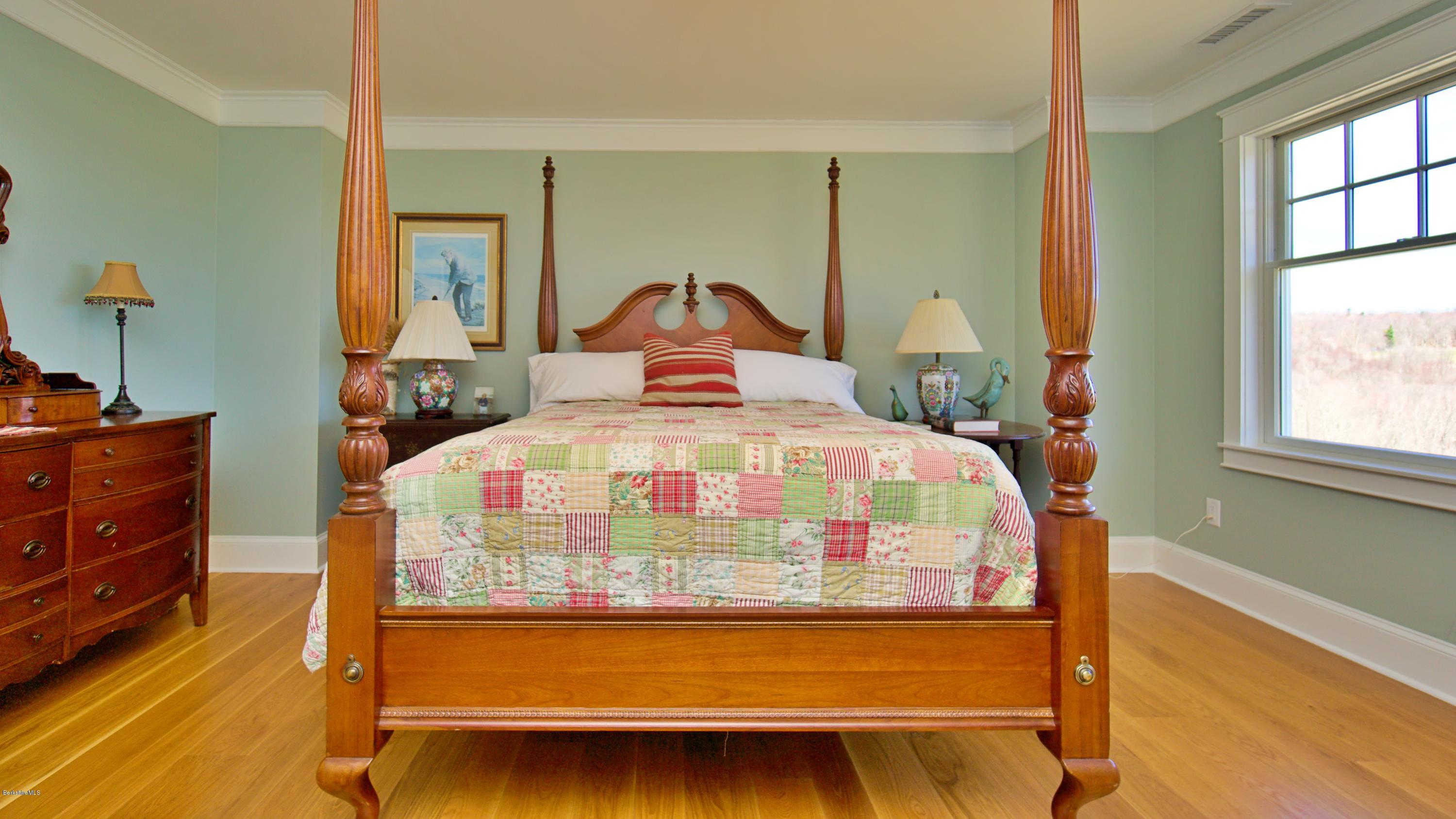 32 Oxbow Road Egremont, MA 01230 - Photo 25 of 35 a bedroom with a bed and a dresser next to a window