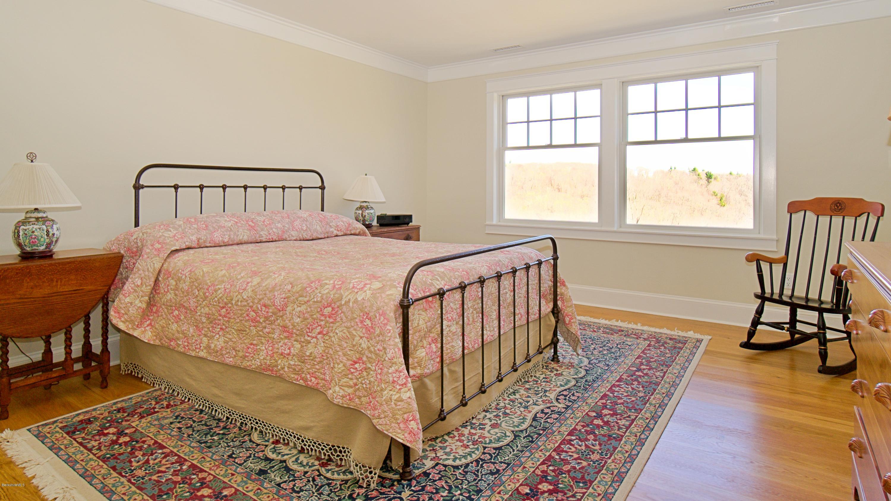 32 Oxbow Road Egremont, MA 01230 - Photo 27 of 35 a bedroom with a bed and wooden floor