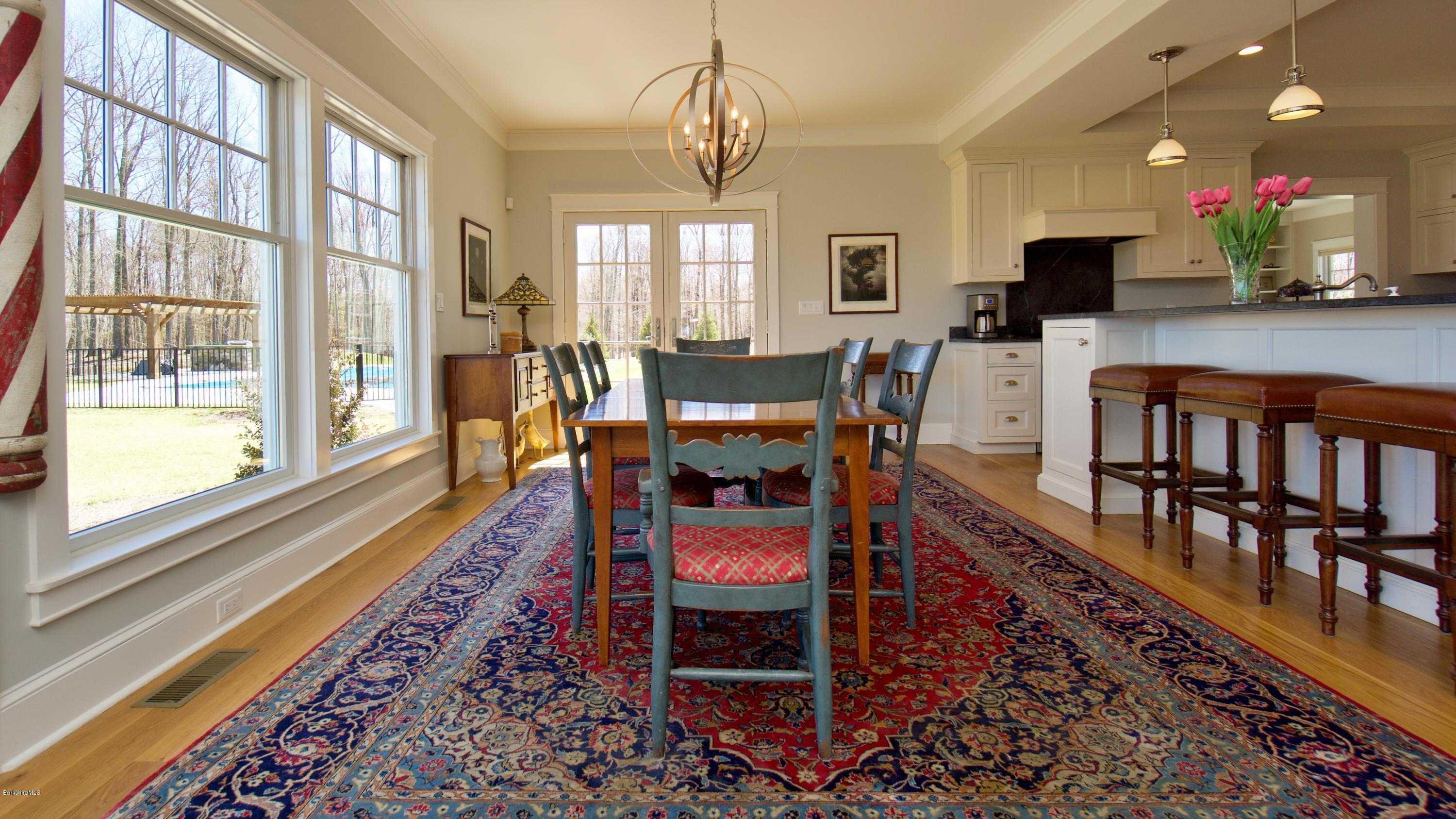 32 Oxbow Road Egremont, MA 01230 - Photo 7 of 35 a dining room with furniture a rug and a floor to ceiling windows