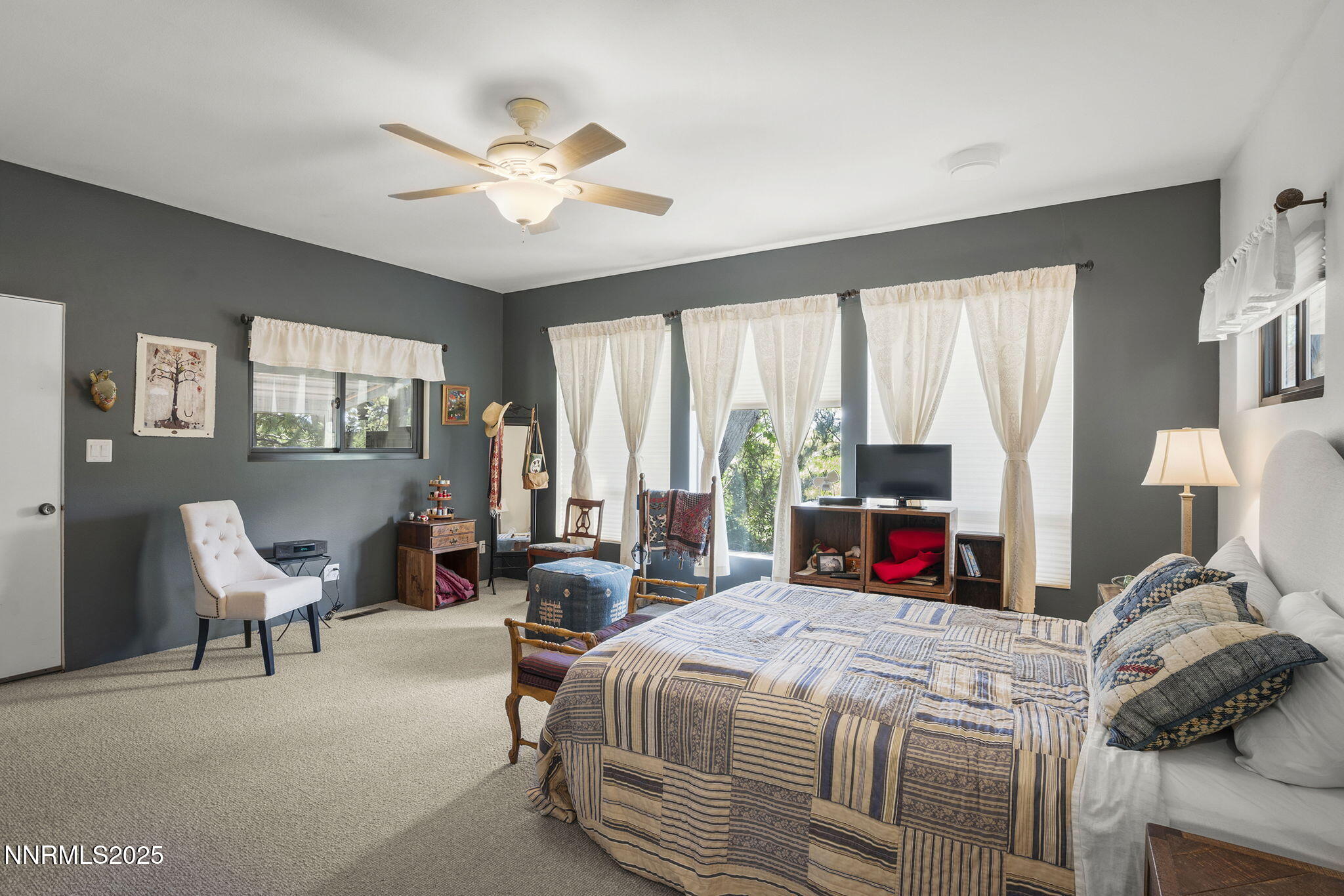 2548 Jacks Valley Road Genoa, NV 89411 - Photo 23 of 51 a bedroom with a bed and large windows