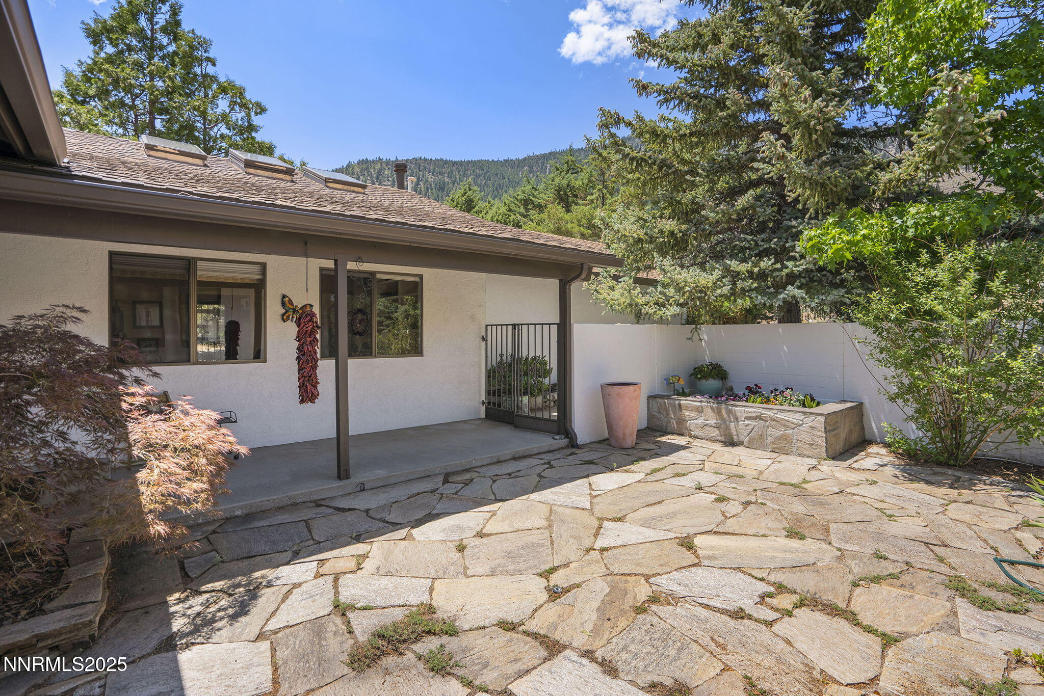 2548 Jacks Valley Road Genoa, NV 89411 - Photo 5 of 51 a front view of a house with a yard and garage
