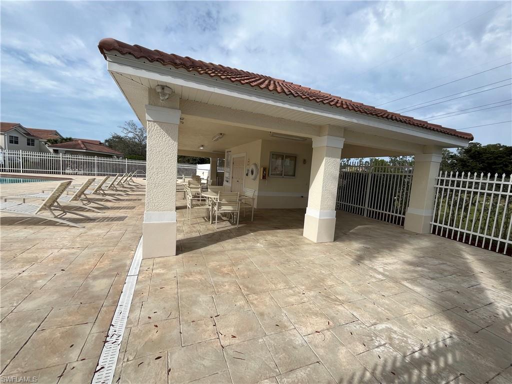884 Hampton Circle, Unit 159 Naples, FL 34105 - Photo 24 of 28 a view of a patio with table and chairs