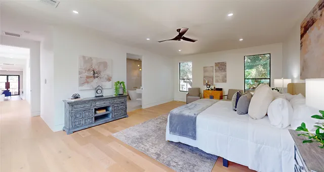 a bedroom with a bed lamps and window