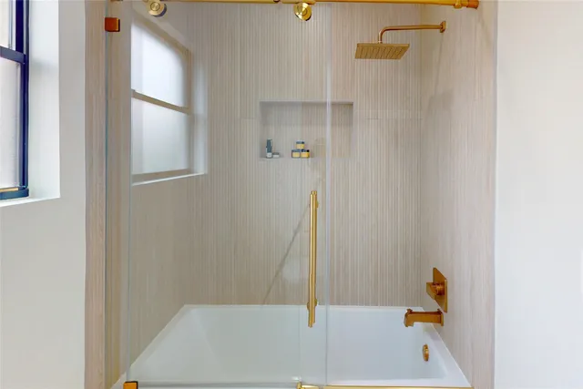 a bathroom with a tub and shower