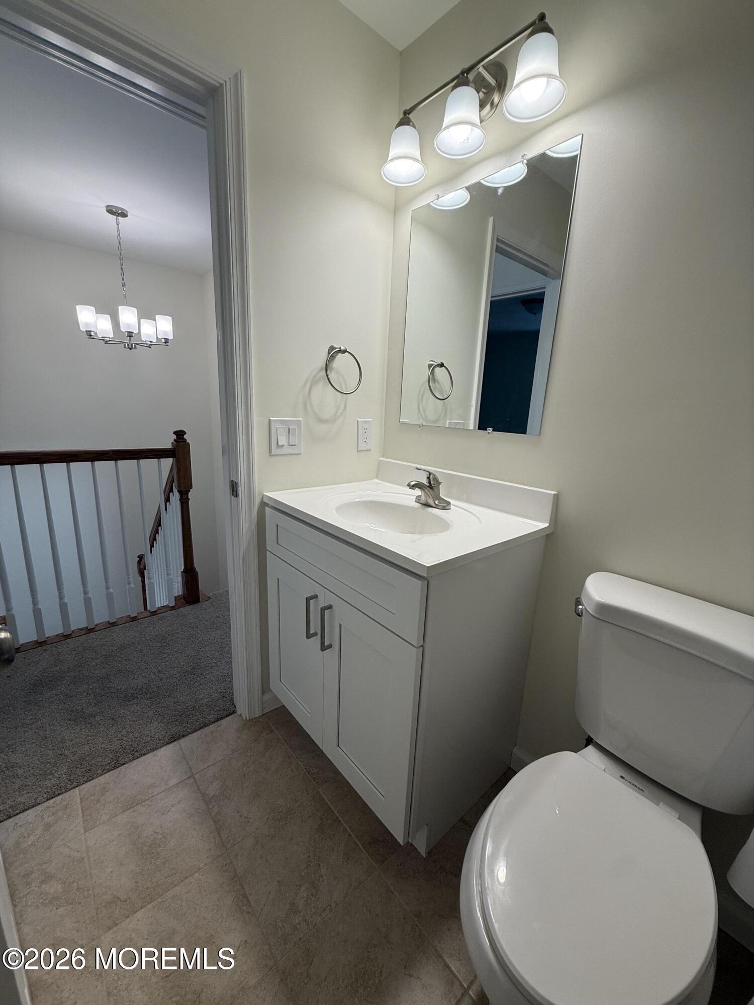 5 Canary Circle Howell, NJ 07731 - Photo 24 of 32 a bathroom with a toilet sink and mirror
