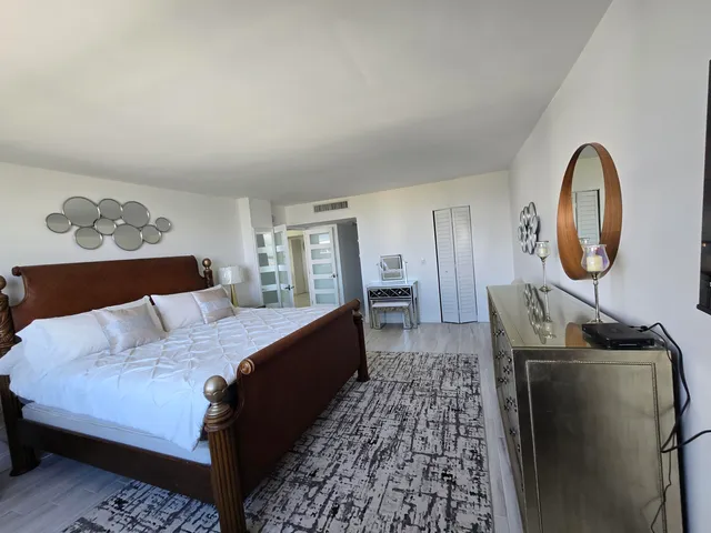 a bedroom with a bed and a dresser