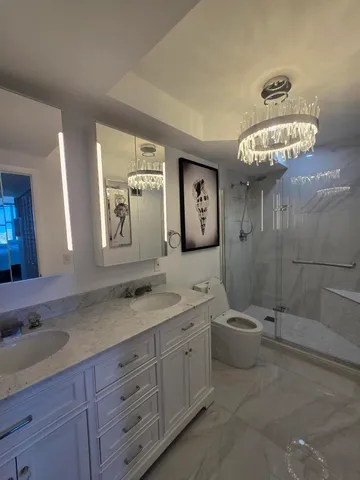 a spacious bathroom with a granite countertop sink mirror and toilet